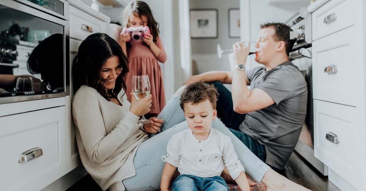 Mom, dad, daughter and son in the kitchen at home