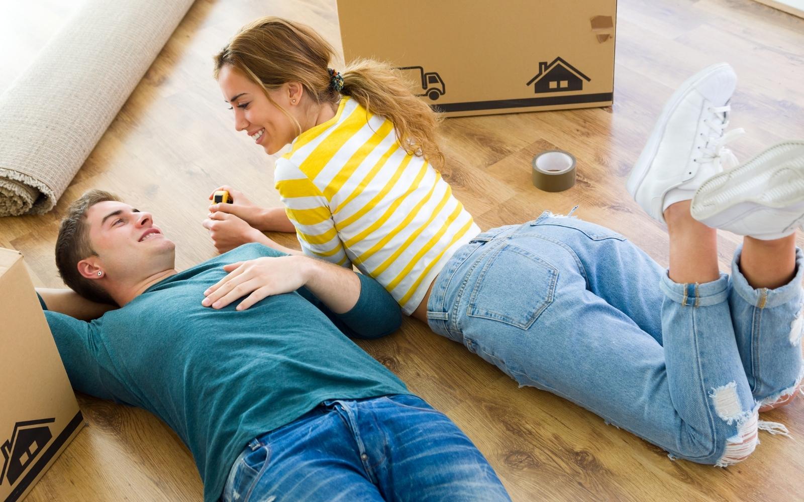 Couple unpacking moving boxes